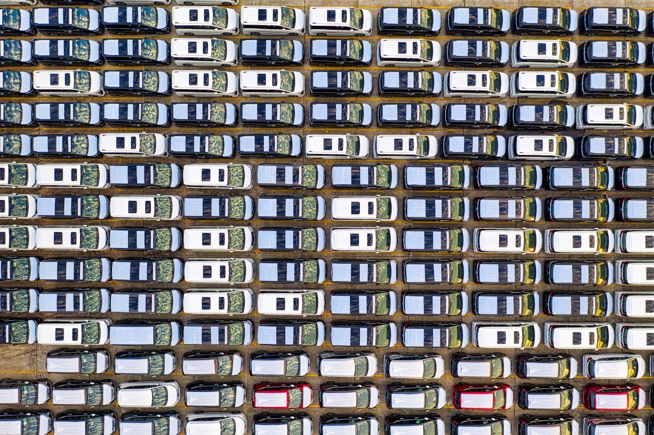 Overhead drone shot showing perfectly aligned cars parked in Jakarta, Indonesia.